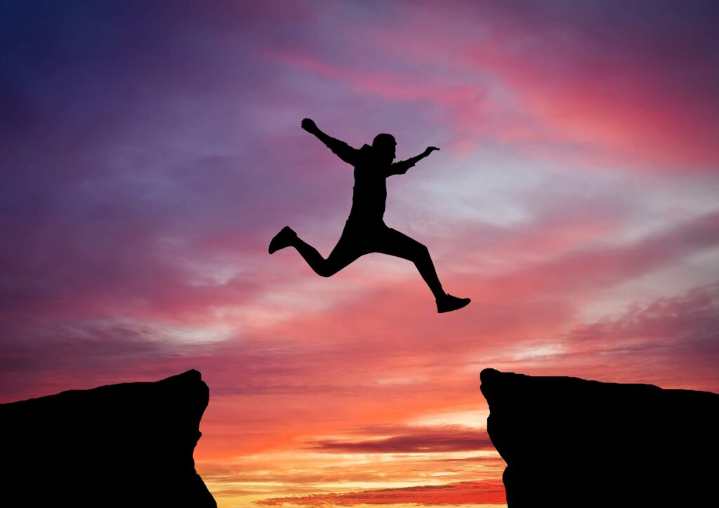 A dark sunset scene showing a plane landing with its lights on, symbolizing the unequal weight of moving abroad and how some people land softly while others land hard.