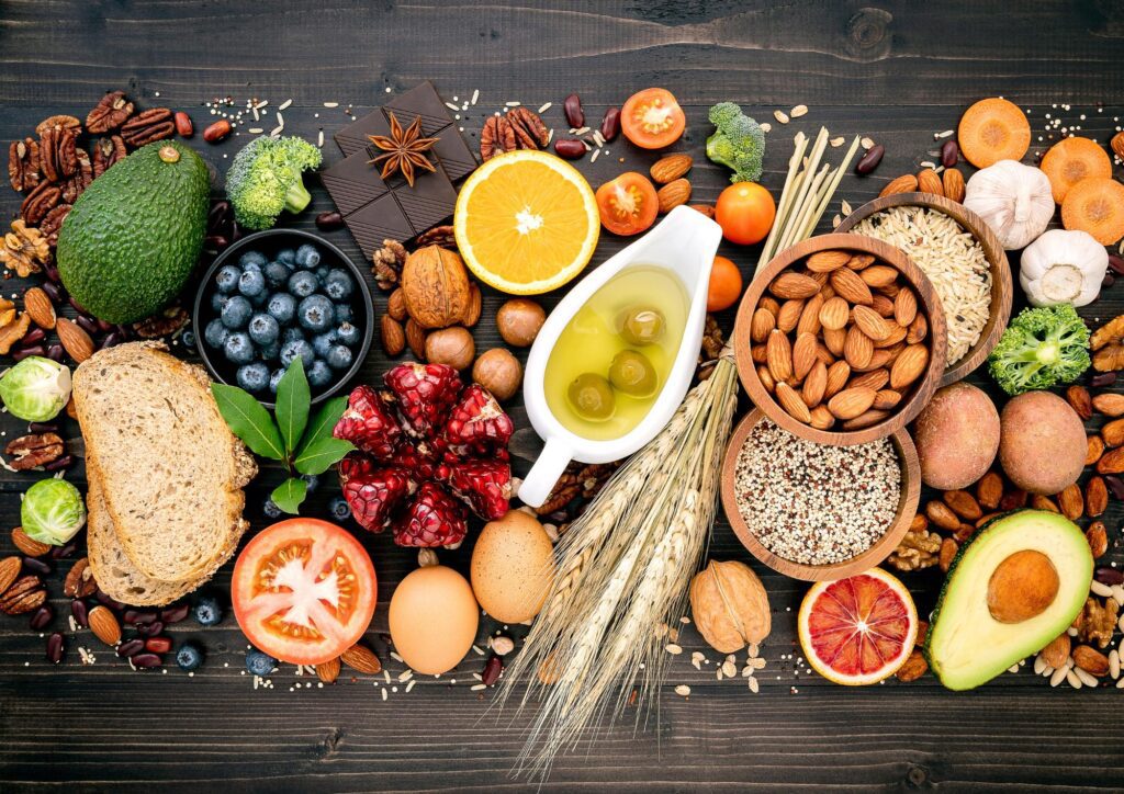 A selection of plant‑based foods including vegetables, fruits, nuts, and whole grains, reflecting the Blue Zones approach to healthy eating.